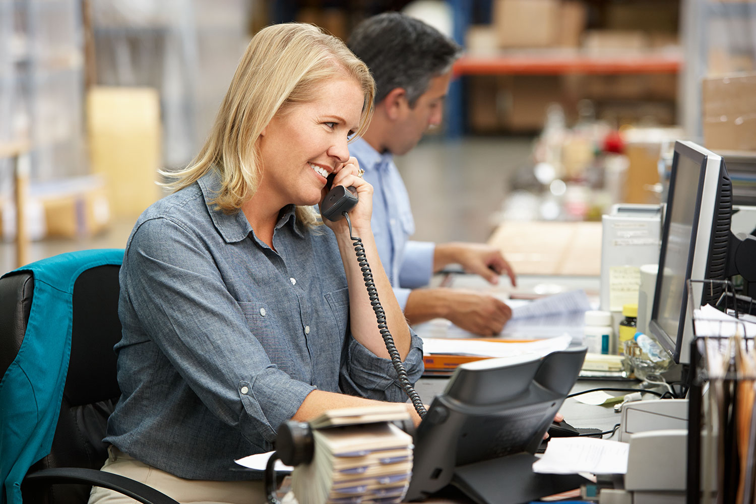 Smiling-lady-in-warehouse-shutterstock_129614792